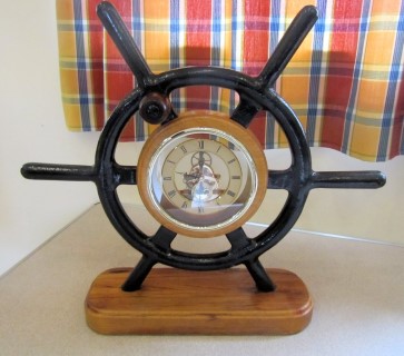Clock set into aluminium ships wheel by Pat Hughes